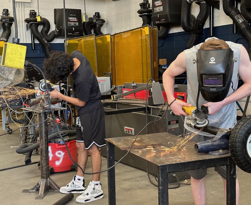 Two apprentices using rotary grinders during a Bayha Group RAP session